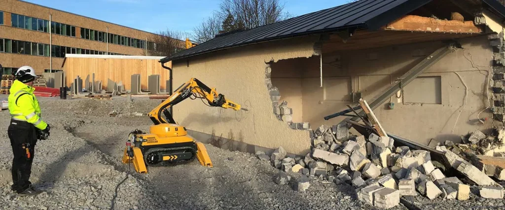 Vår maskin som river en byggnad av betong